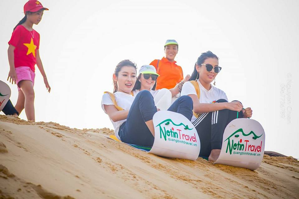 Miss Vietnam participates in a sandboarding game at Quang Phu sand dunes organized by Netin travel